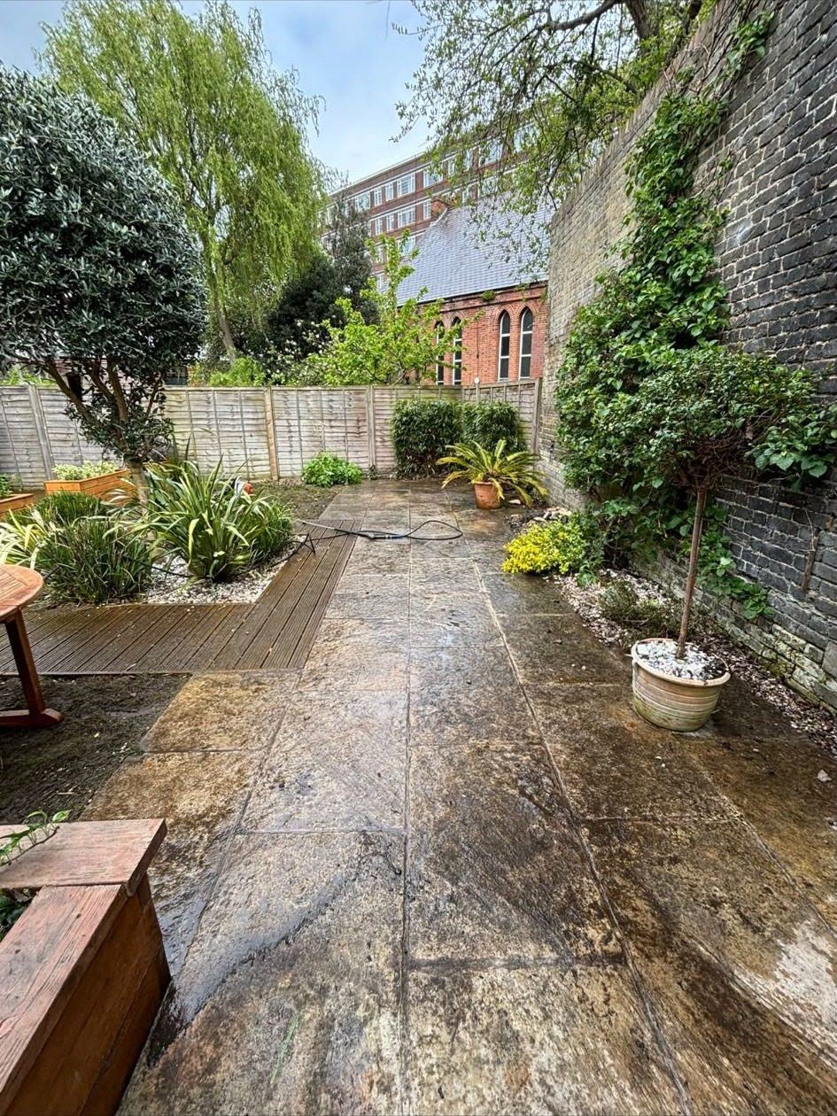 A patio half cleaned, showing the difference